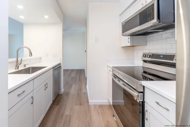 a kitchen with a stove microwave and a sink