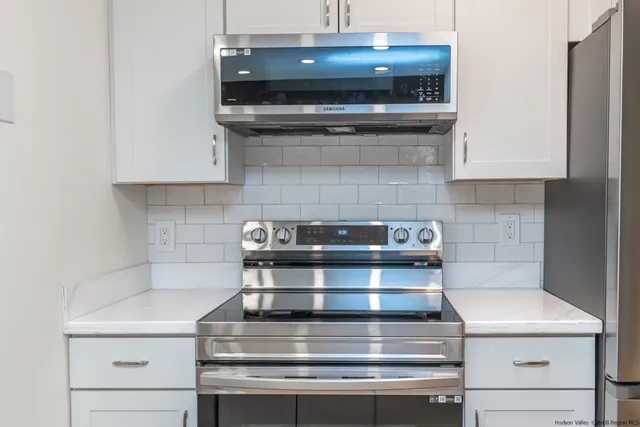 a stove top oven sitting inside of a kitchen