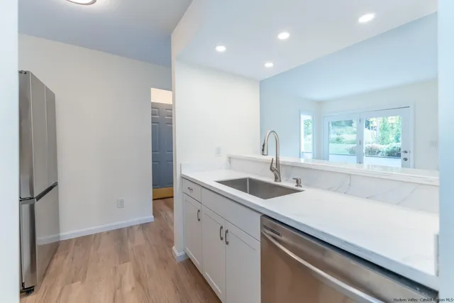a kitchen with a sink and a large window