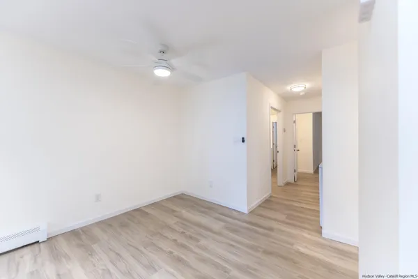 a view of a room with wooden floor