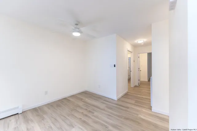 a view of a room with wooden floor