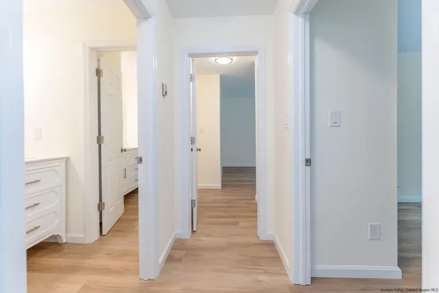 a view of a hallway with wooden floor