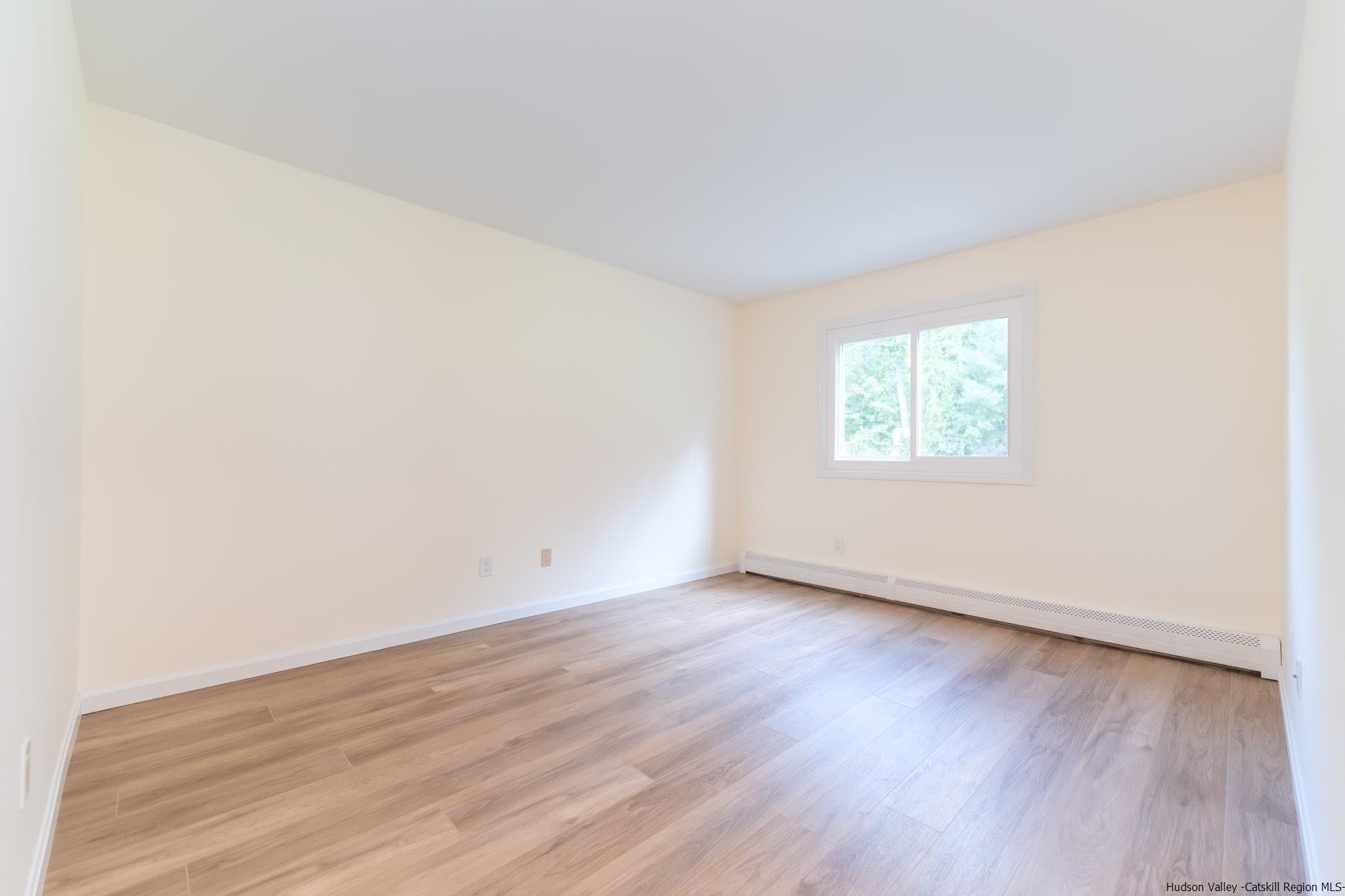 4 Tiger Maple Lane Saugerties, NY 12477 - Photo 20 of 35 an empty room with wooden floor and windows
