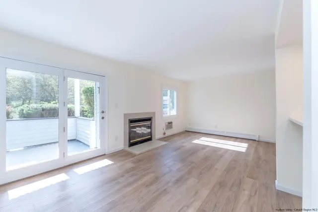 a view of an empty room with glass door