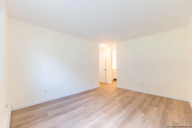 a view of an empty room and wooden floor