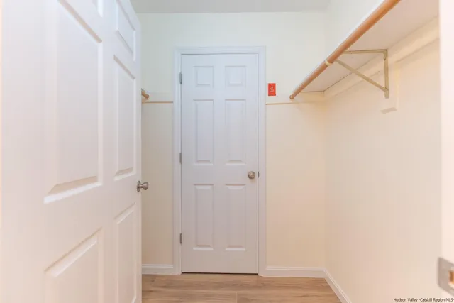 a view of hallway with wooden floor