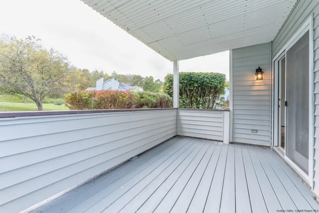 a view of a balcony with wooden floor