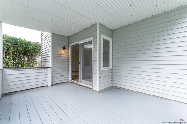 a view of a porch with wooden floor