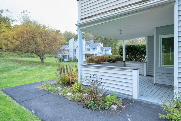 a view of a patio with a table and chairs under an umbrella