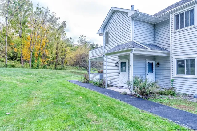 a view of a house with yard and a garden