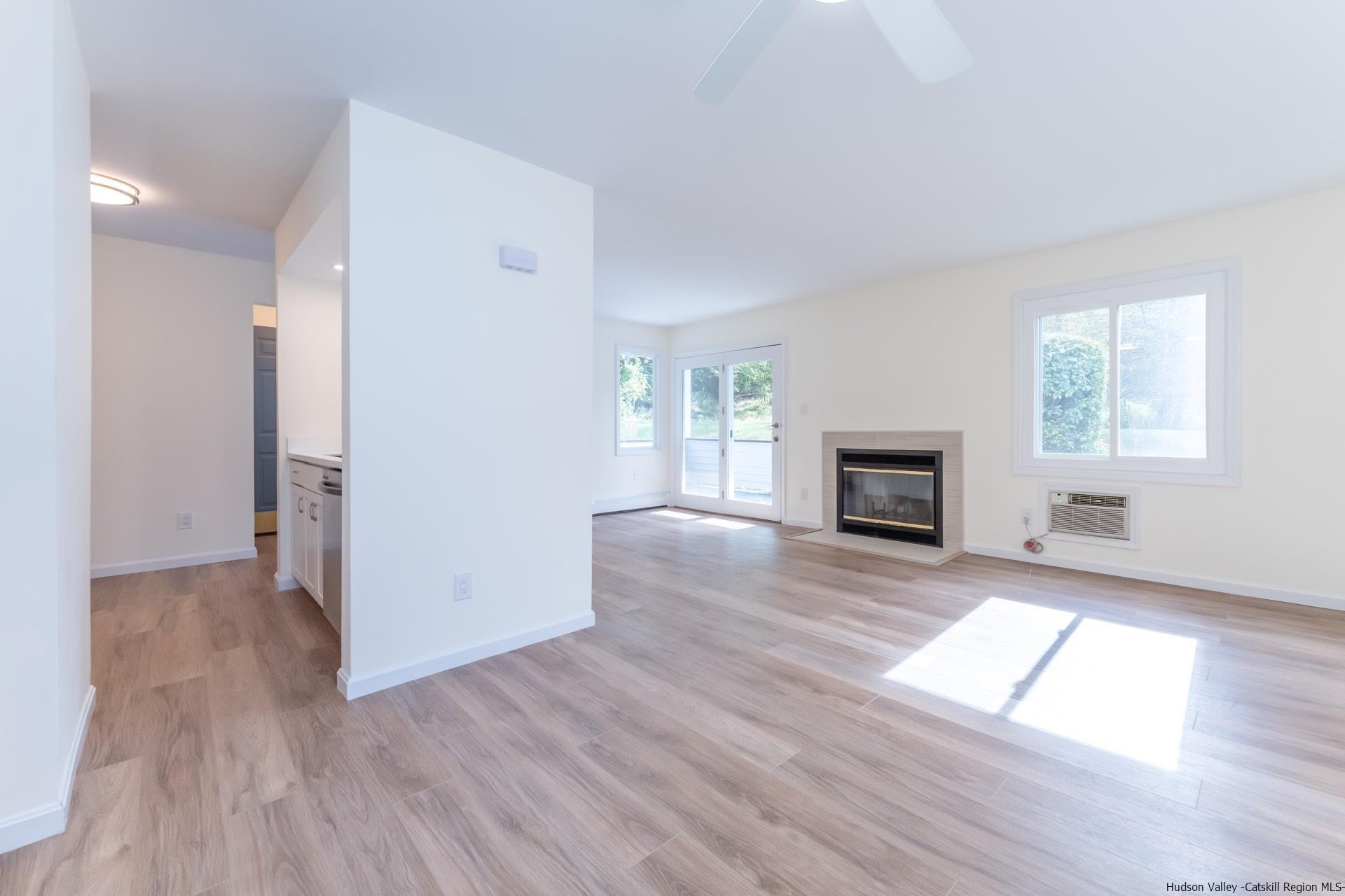 4 Tiger Maple Lane Saugerties, NY 12477 - Photo 4 of 35 an empty room with windows and a fireplace