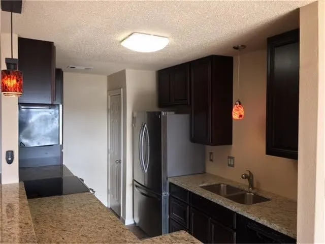a kitchen with a refrigerator and a sink
