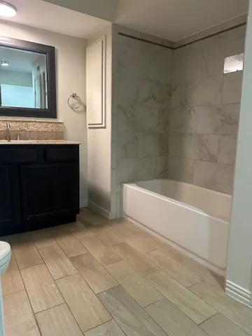 a bathroom with a bathtub and a shower