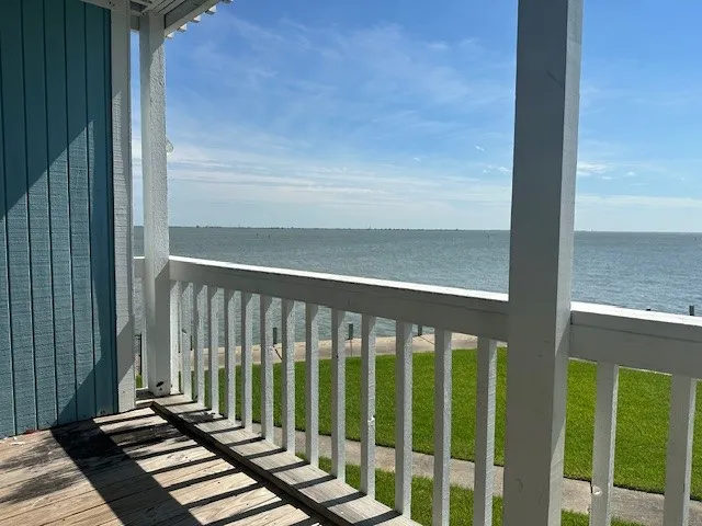 a view of a balcony with wooden floor