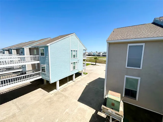 a view of a sign in a yard with potted plants