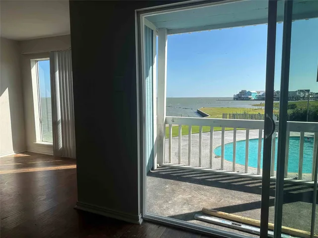 a view of balcony with a floor to ceiling window and wooden floor
