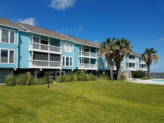 a front view of a building with a garden