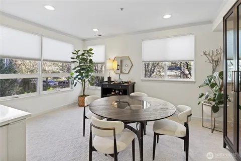 a view of a dining room with furniture and a potted plant