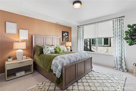 a bedroom with a large bed and a couch