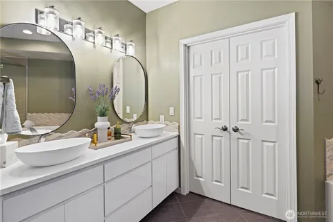 a bathroom with a double vanity sink and a mirror