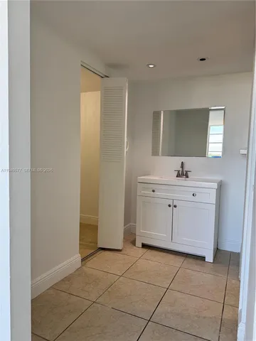 a bathroom with a sink vanity and mirror