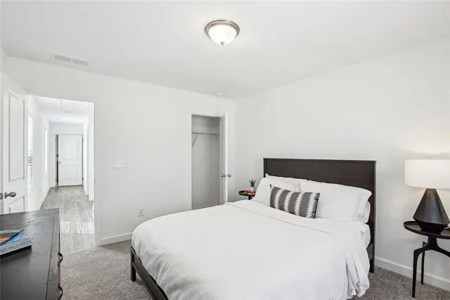 a bedroom with a bed and chair