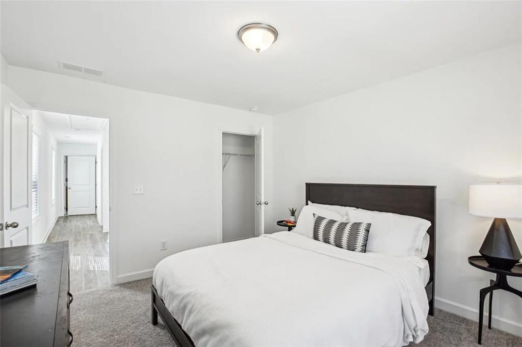 4113 Leatherwood Lane Powder Springs, GA 30127 - Photo 4 of 11 a bedroom with a bed and chair