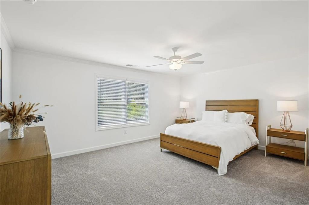 4113 Leatherwood Lane Powder Springs, GA 30127 - Photo 5 of 11 a bed sitting in a bedroom next to a window and a chandelier