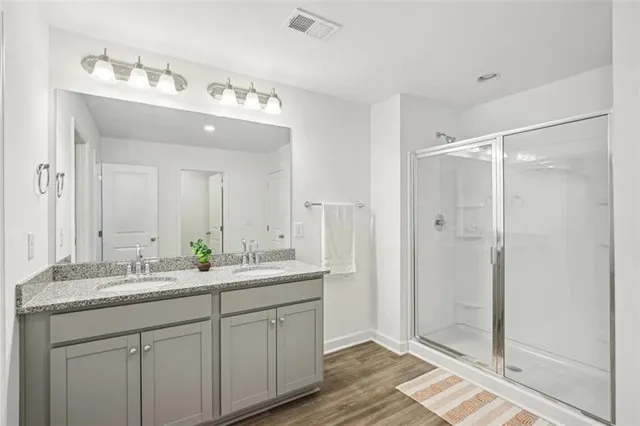 a bathroom with a sink double vanity and a mirror