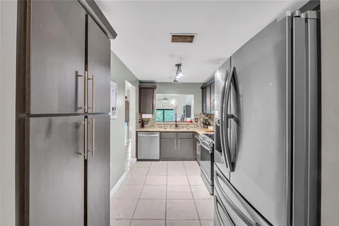 a kitchen with a refrigerator and a sink