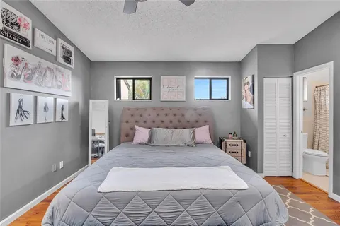 a bedroom with a large bed and a chandelier