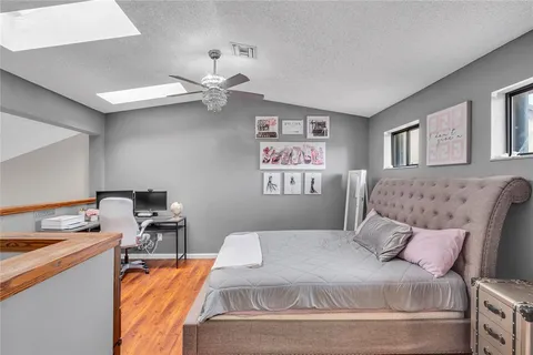 a bedroom with a bed and a chandelier