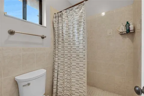 a bathroom with a shower and a toilet