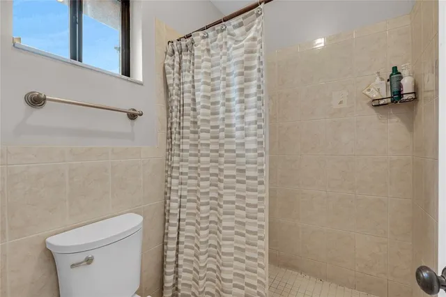 a bathroom with a shower and a toilet