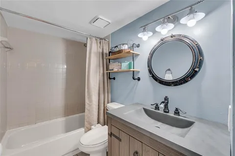 a bathroom with a sink a toilet and a mirror