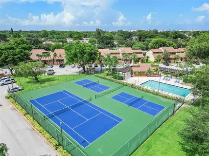 a view of a tennis ground with a city view