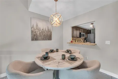 a dining room with furniture and window