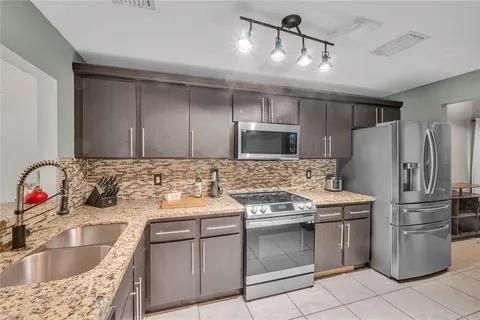 a kitchen with a sink stove and refrigerator