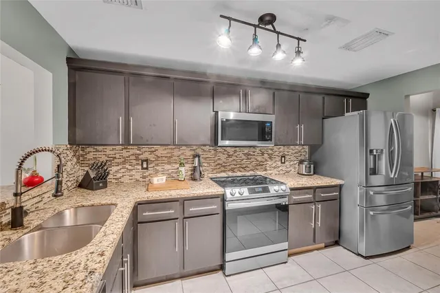 a kitchen with a sink stove and refrigerator