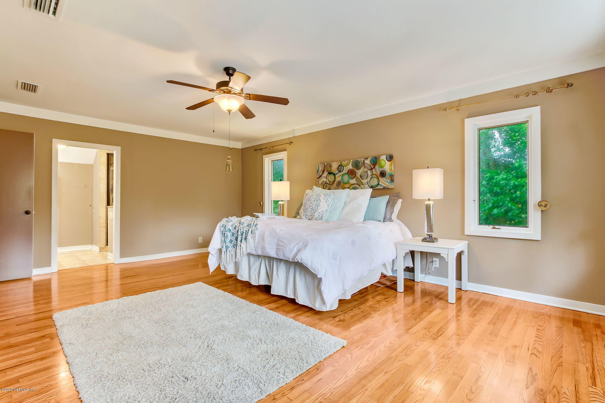 12193 Mandarin Road Jacksonville, FL 32223 - Photo 16 of 45 a bedroom with a bed and wooden floor