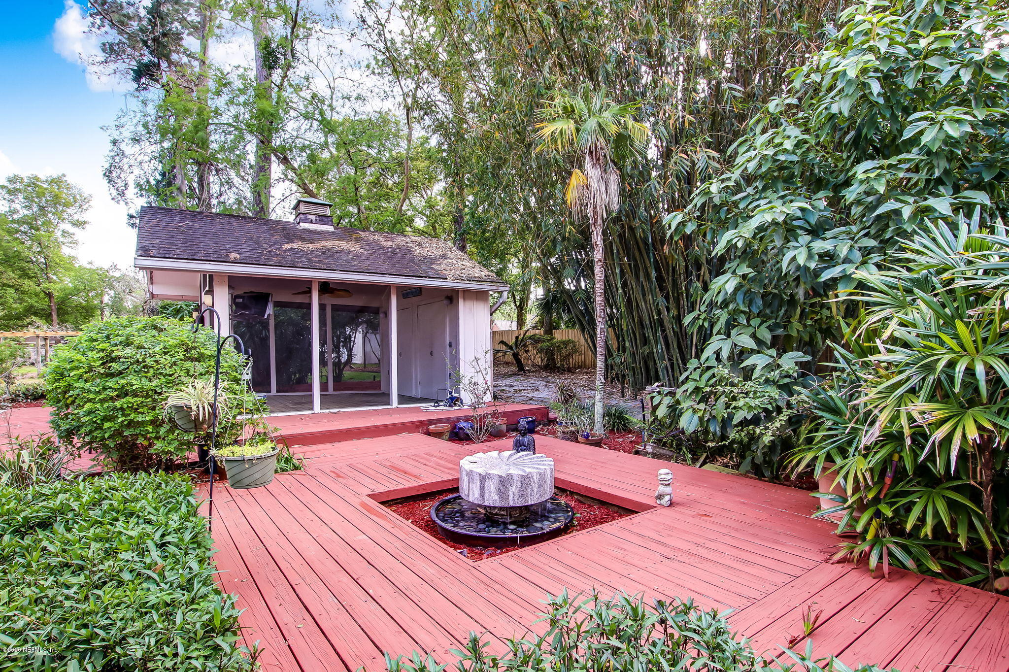 12193 Mandarin Road Jacksonville, FL 32223 - Photo 28 of 45 a view of a patio with table and chairs potted plants and large tree