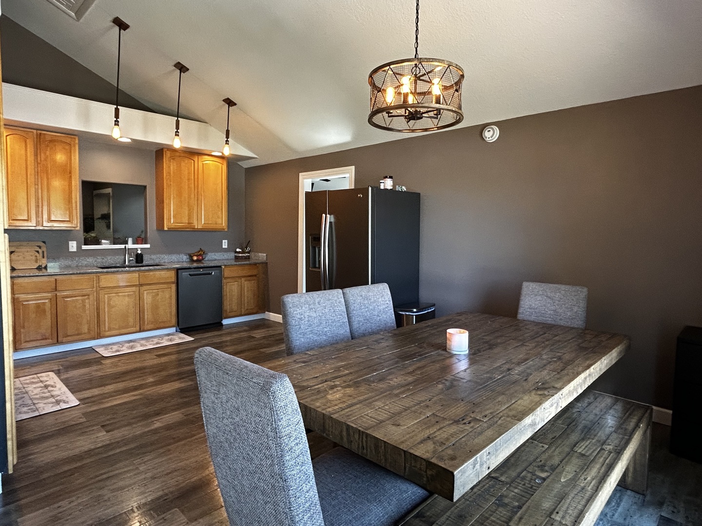 12795 Lawrence Road Sterling, IL 61081 - Photo 19 of 42 a kitchen with a table chairs refrigerator and microwave