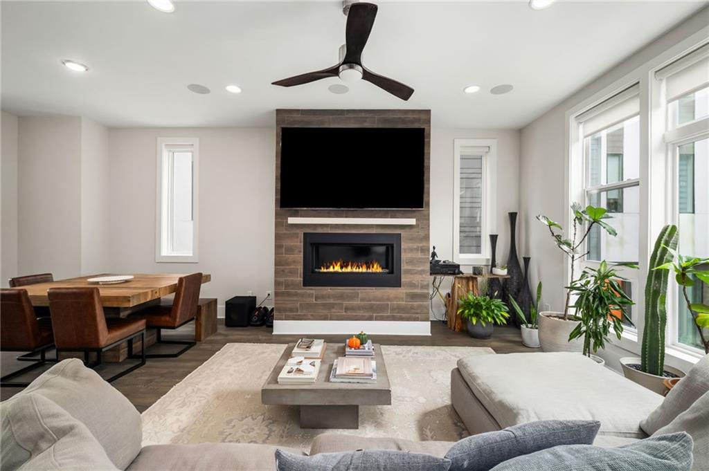 52 Reynolds Square Lane Atlanta, GA 30307 - Photo 12 of 32 a living room with furniture a flat screen tv and a fireplace