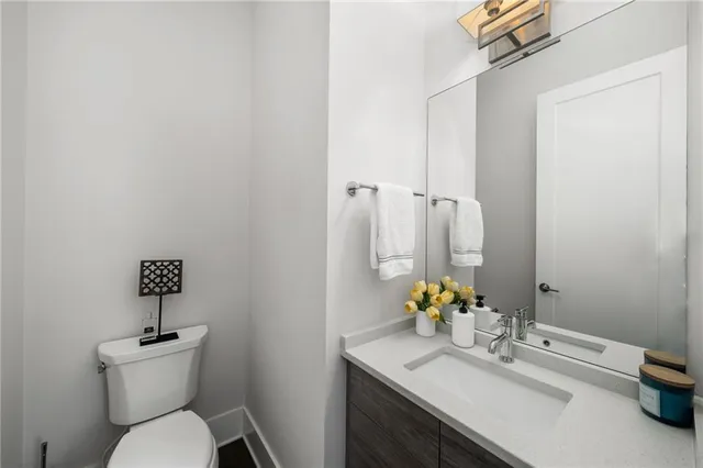 a bathroom with a sink toilet and mirror