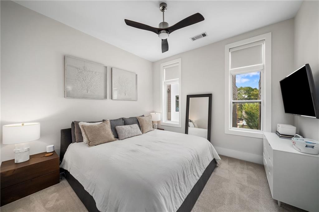 52 Reynolds Square Lane Atlanta, GA 30307 - Photo 15 of 32 a bedroom with a bed flat screen tv and a window