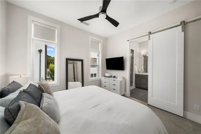 a bedroom with a bed and a flat screen tv