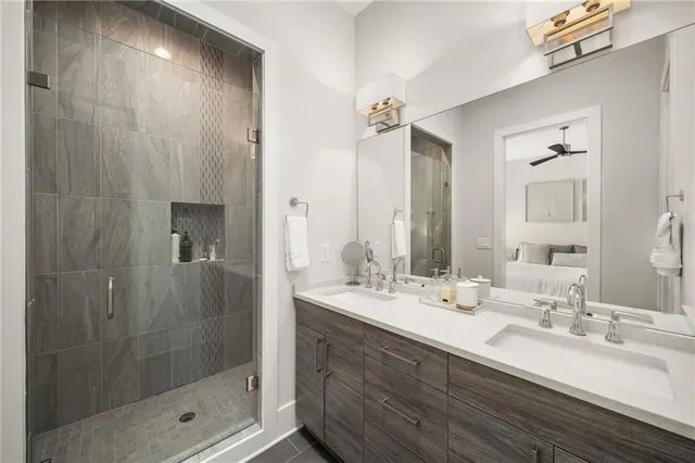 a bathroom with a double vanity sink mirror and shower