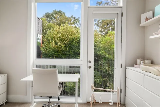 a view of bathroom with a window and a potted plant