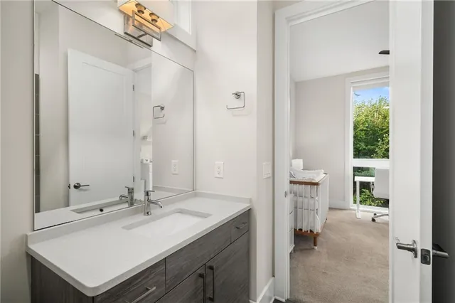 a en suite bathroom with a sink and a mirror