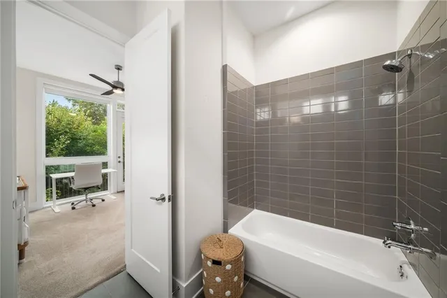 a bathroom with a tub and a shower